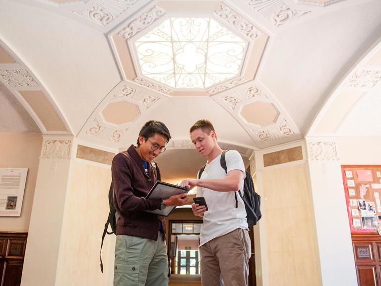 Image card - Two students looking at reading materials